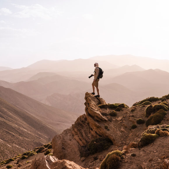 Man with a camera on a rock