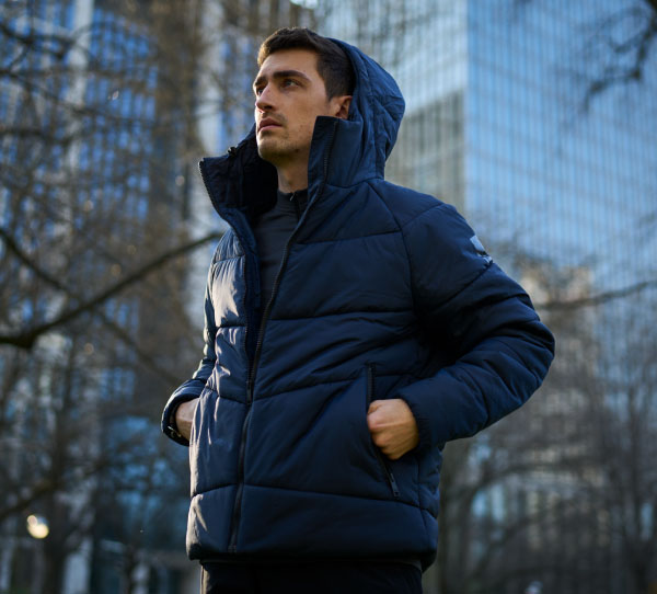 Man wearing a blue quilted jacket