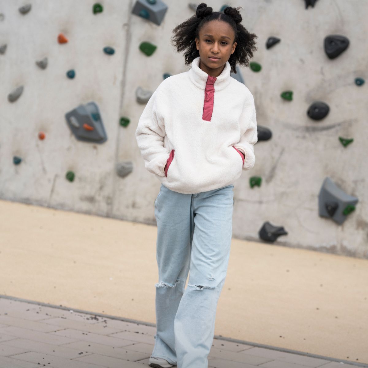 Girl in front of climbing wall
